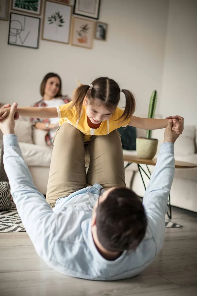 Father lifting daughter in the air playfully